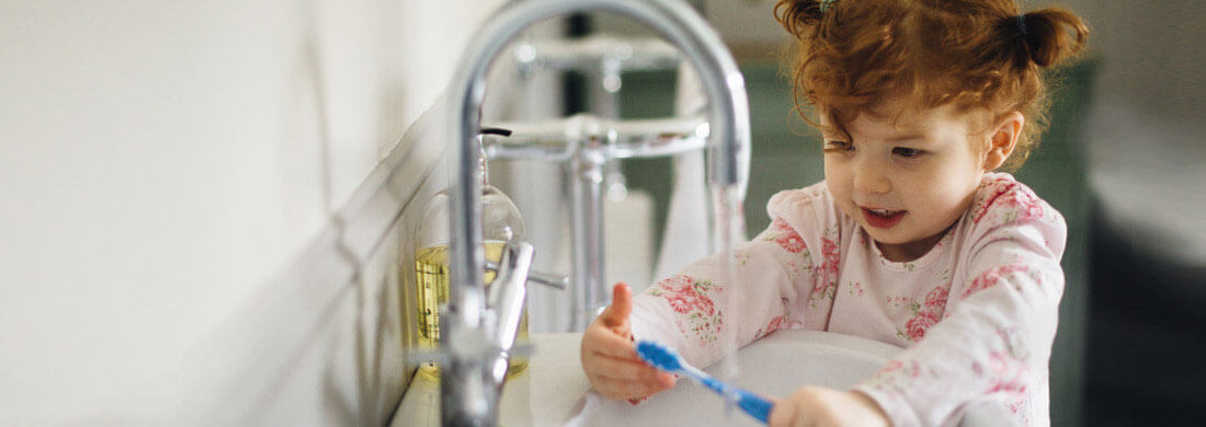 child washing toothbrush in sink bathroom faucet lead titanium series